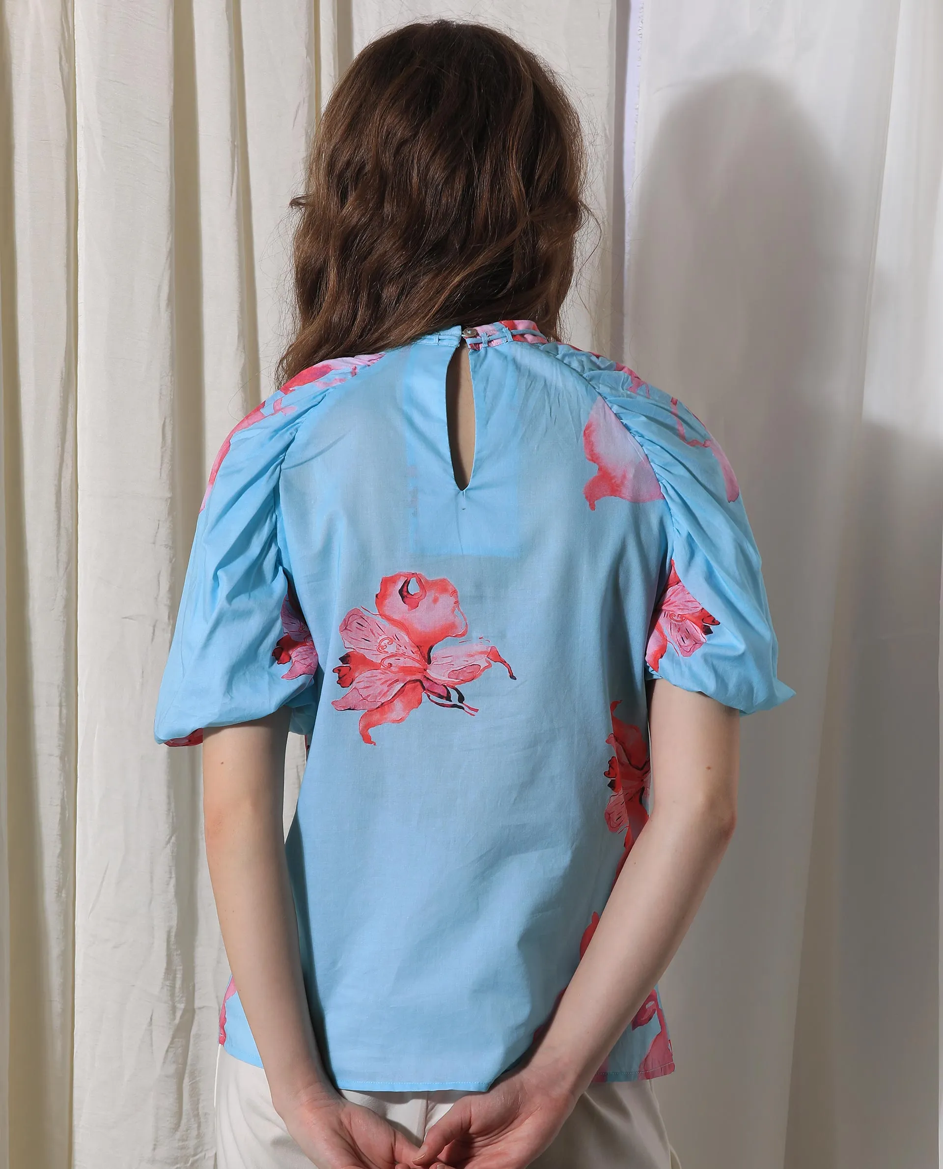 Rareism Women Kink Blue Cotton Fabric Short Sleeves Button Closure Tie-Up Neck Puff Sleeve Relaxed Fit Floral Print Top