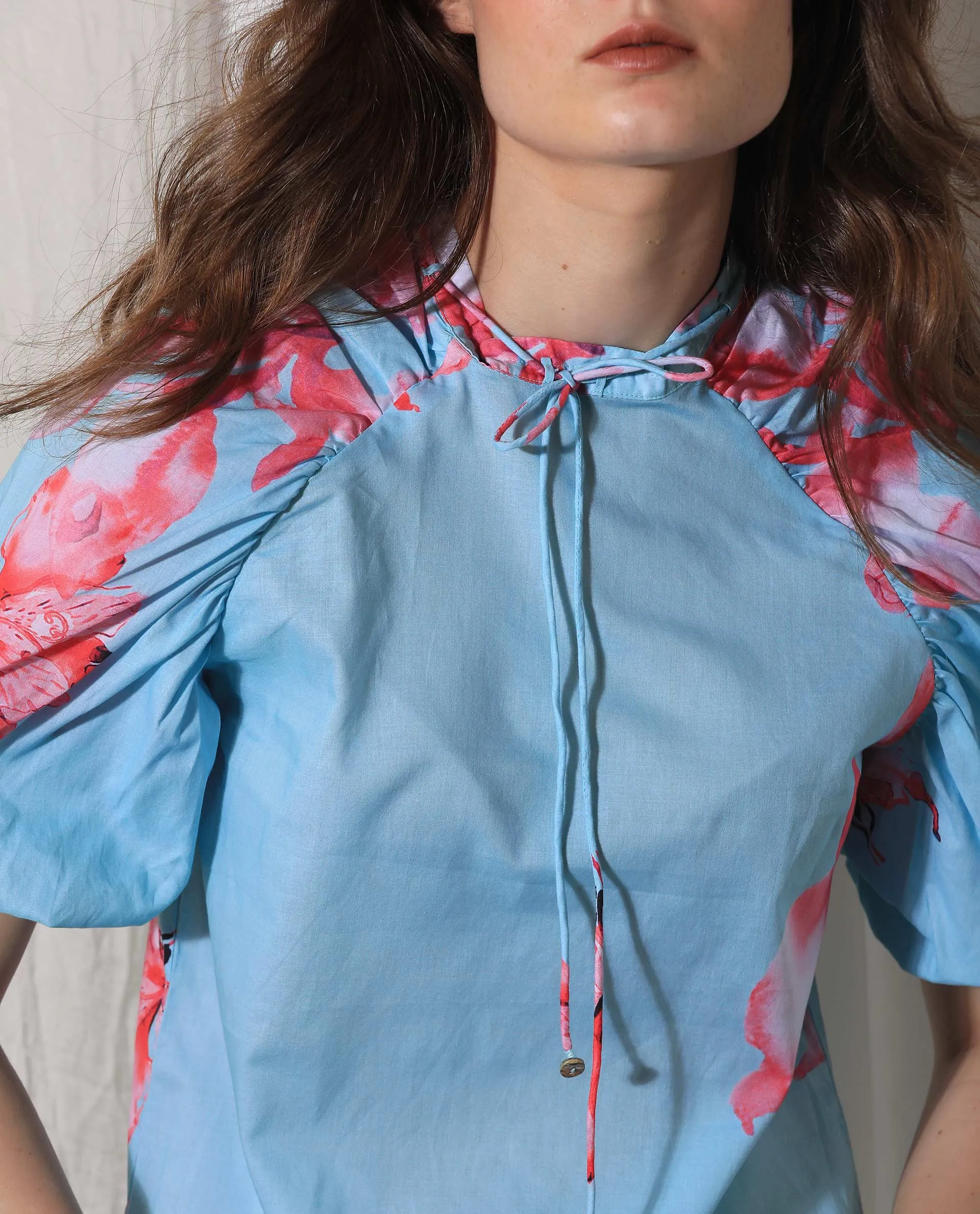 Rareism Women Kink Blue Cotton Fabric Short Sleeves Button Closure Tie-Up Neck Puff Sleeve Relaxed Fit Floral Print Top