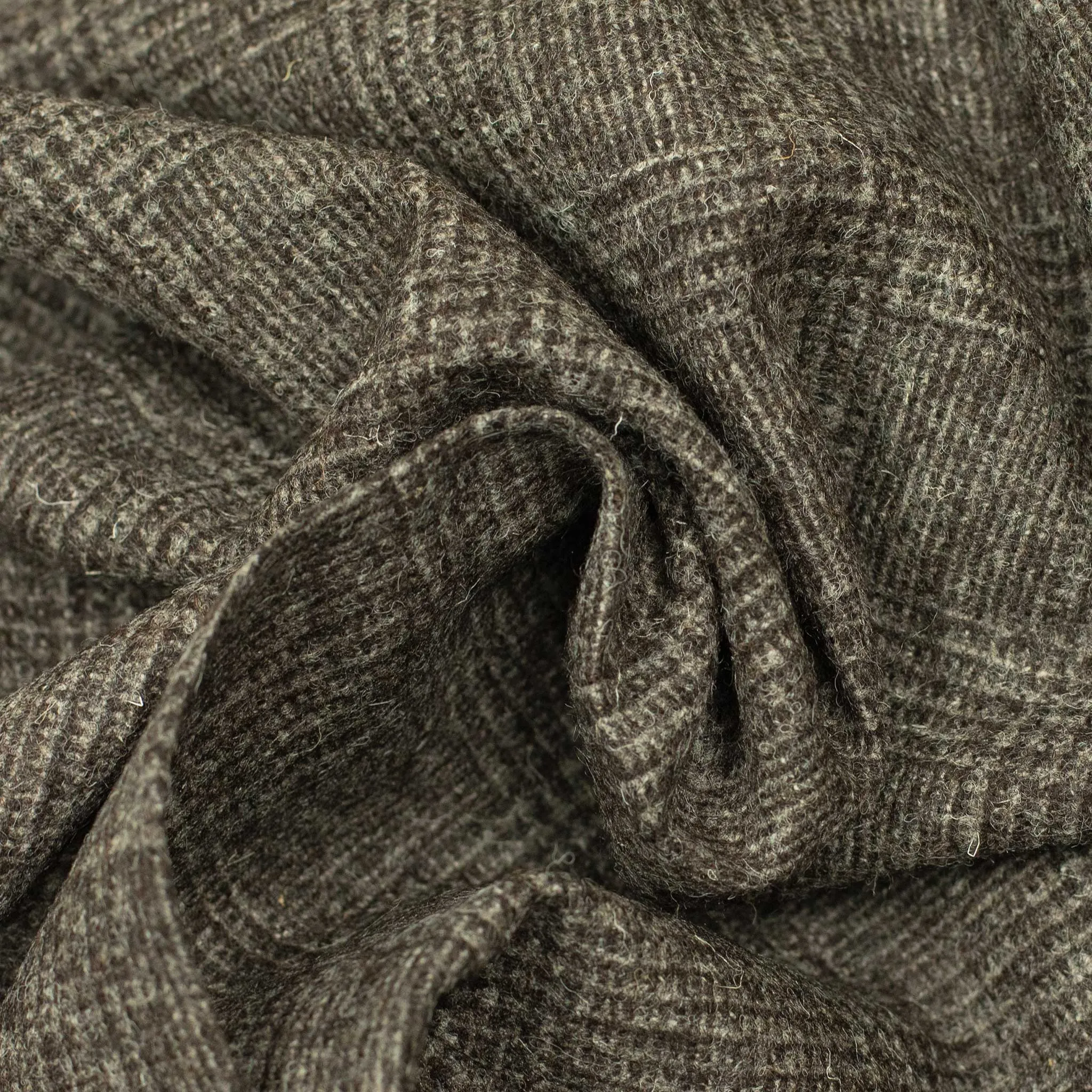 x Sartoria Carrara: Pleated trousers in tonal charcoal Prince-of-Wales undyed wool